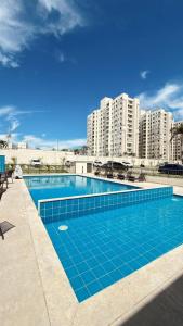 a swimming pool in front of some tall buildings at 098house in São Luís