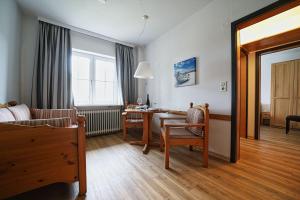 a living room with a table and a dining room at Appartement-3 in Süddorf