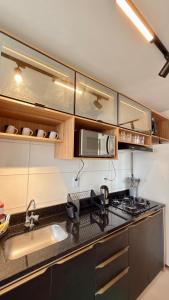 a kitchen with a sink and a stove top oven at 098house in São Luís