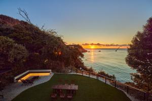 a view of the ocean at sunset with chairs and tables at UMIBE IseShima in Shima +33 photos