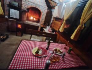 a table with a plate of food on a red and white table cloth at Brvnara Sofiana in Bajina Bašta +70 photos