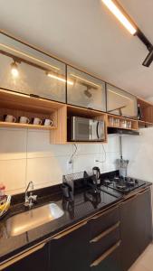 a kitchen with a sink and a stove top oven at House098 in São Luís