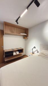 a bedroom with a bed and a desk with a lamp at House098 in São Luís +13 photos