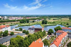 an aerial view of a city with a river and buildings at Apartments in Trebbin 26568 in Trebbin