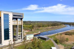 a large building with a river in the background at Apartments in Trebbin 26568 in Trebbin