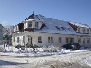 a large white house with snow on the ground at Apartments in Trebbin 26568 in Trebbin