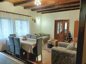 a living room with a couch and a table with a laptop at Brvnara Sofiana in Bajina Bašta