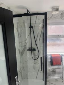 a shower with a glass door in a bathroom at The Woodquay House in Galway