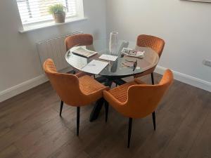a dining room table with chairs and a glass table at The Woodquay House in Galway +13 photos