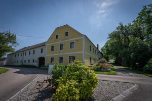a large yellow building on the side of a road at Landhof Lydia in Roggendorf +22 photos
