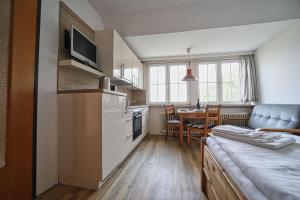 a kitchen with a table and a dining room at Appartement-6 in Süddorf +8 photos