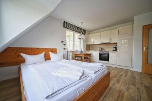 a large bedroom with a large bed with white sheets at Appartement-7 in Süddorf