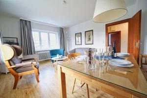 a living room with a table and a dining room at Appartement-9 in Süddorf