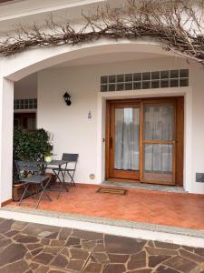 a patio with a wooden door and a table at Luciana House in Olbia
