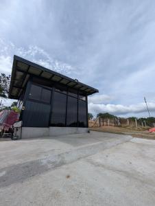 a building with a black roof on top of a parking lot at The G Residence in Calatagan