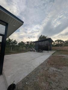 a pavilion with a picnic table in a field at The G Residence in Calatagan +8 photos