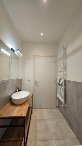 a bathroom with a white sink and a shower at CA' VARADE di Martina Scarduelli in Varallo +13 photos
