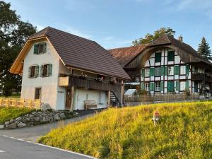 a large white house with a brown roof at Stöckli Gantrisch-Blick in Rüeggisberg