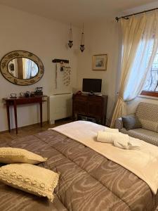a bedroom with a large bed and a mirror at Liguorini House in Avellino