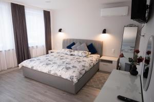 a bedroom with a bed and a mirror in it at Dzūkija Hotel in Alytus