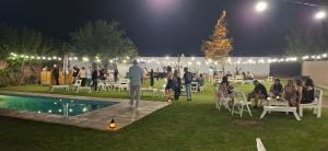 a group of people sitting around a pool at a party at Hotel Dalai in Mendoza +20 photos