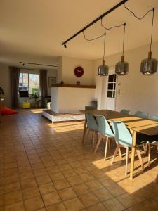 a living room with a table and chairs at Villa Oni met grote speelruimte in Koksijde