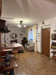 a living room with a bed and a couch at Liguorini House in Avellino