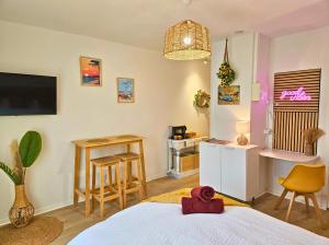 a bedroom with a bed and a table and a desk at ''Coccinelle'' WIFI - CENTRE - MODERNE in Dax
