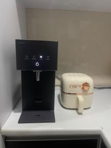 a coffee maker and a toaster sitting on a counter at Afiq's Homestay, Manjung in Seri Manjung
