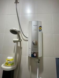 a machine in a bathroom with a toilet at Afiq's Homestay, Manjung in Seri Manjung