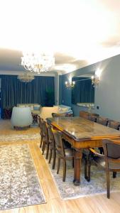 a dining room with a wooden table and chairs at Apartment on the Nile, 3 bedrooms and a living room in Cairo