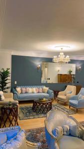 a living room with couches and chairs and a mirror at Apartment on the Nile, 3 bedrooms and a living room in Cairo +21 photos
