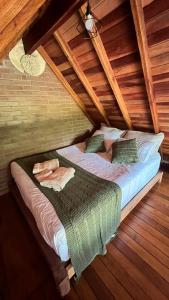 a large bed in a room with wooden ceilings at Cabana na Mata Paraíso da Serra in Aquidauana