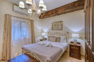 a bedroom with a bed with two stuffed animals on it at Stunning 2BR Villa with Pool in Mġarr +75 photos