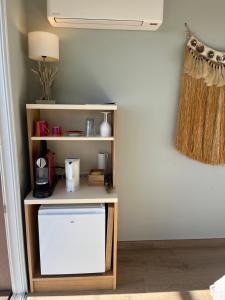 a book shelf with a tv in a room at Saint Clair, la plage à pied in Le Lavandou +49 photos