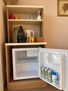 a white refrigerator with its door open in a kitchen at Saint Clair, la plage à pied in Le Lavandou