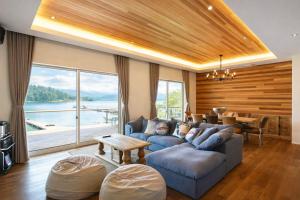 a living room with a blue couch and a table at The Lake House 野尻湖 in Shinano