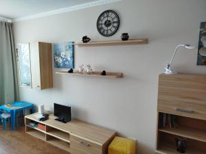 a room with a desk and a clock on the wall at FourSpace in Ventspils