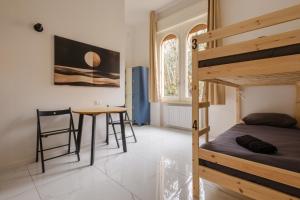 a bedroom with a bunk bed and a table at A Casa Gualandi in Bologna