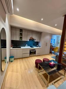 a kitchen with a table and some chairs in a room at Sky High Nest Noida in Ghaziabad