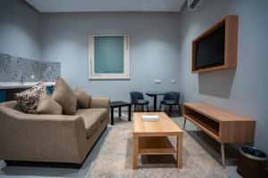 a living room with a couch and a table at Nozol Tabba in Medina