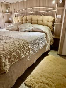 a bedroom with a large bed with a white comforter at L'Angolo Tranquillo in Monterosso al Mare
