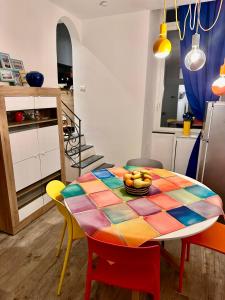 a kitchen and dining room with a colorful table and chairs at L'Angolo Tranquillo in Monterosso al Mare