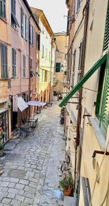an alley in a city with tables and buildings at L'Angolo Tranquillo in Monterosso al Mare