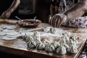 a person is preparing food on a table at Gugoshvili's Cellar in Kvareli