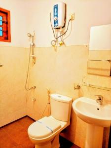 a bathroom with a toilet and a sink at Ceyonra Evermist Residence in Nuwara Eliya +31 photos