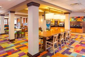 a dining room with a table and chairs at Fairfield Inn & Suites Atlanta McDonough in McDonough