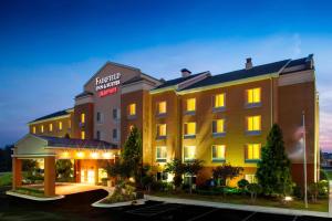 a hotel with a lit up building in a parking lot at Fairfield Inn & Suites Atlanta McDonough in McDonough