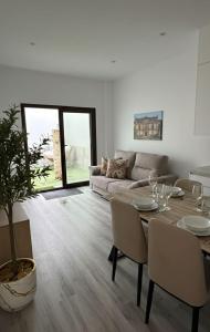 a living room with a table and a couch at Apartamentos San Gabriel in Alcalá de Henares