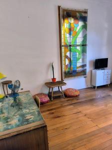 a room with a table and a stained glass window at Habiteca Acentto B&B in Viña del Mar